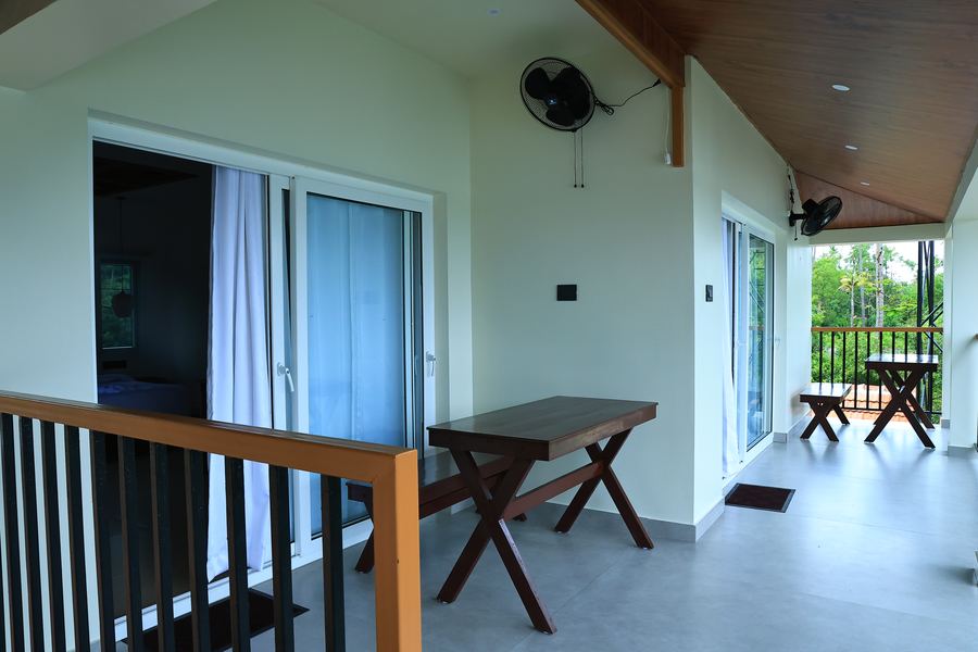 The upstairs balcony with a table and bench