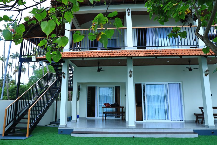 The villa from the garden, with the veranda and upper balcony